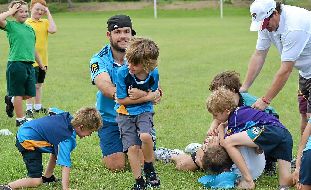TACKLE PRACTICE: Juniors got in some training with Gold Coast’s Nate Myles before the start of last season. TACKLE PRACTICE: Juniors got in some training with Gold Coast’s Nate Myles before the start of last season.
